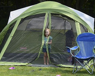 Katie Rickman | The Vindicator.Finley Blackann, 3, of Boardman peeks out of the tent as her father Josh works behind her at Wick Recreation Area at Mill Creek MetroPark August 9, 2014.