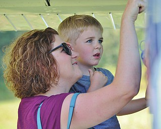Jeff Lange | The Vindicator Sondra Blankenhorn-Cook of Fort Wayne Indiana shows her son Ethan Cook (8) the inside of a plane on display during the Wings and Wheels Fundraiser event held on Saturday at the Ernie Hall Aviation Museum in Warren.