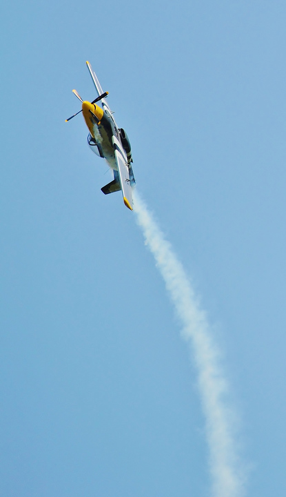 Jeff Lange | The Vindicator  "The Pisser" a T-51 Mustang does a barrel roll during one of the many fly overs that occurred Saturday afternoon during the Wings and Wheels Fundraiser event at the Ernie Hall Aviation Museum.