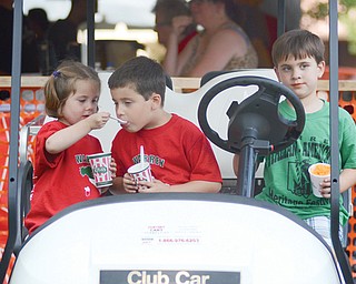 Everleigh Thomas, 3, of Niles shares her Italian ice with her brother Anthony, 5, while their friend Dominic Bowser, 5, of Warren sits beside them in a golf cart at the Italian-American Heritage Festival in Warren on Sunday.