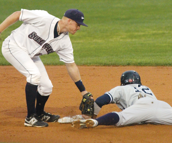 Mahoning Valley Scrappers shortstop Austin Fisher, left, tries to make the tag as Staten Islands’ Vincente Conde (12) slides safely into second base during a game at Eastwood Field in Niles on Monday.