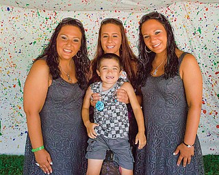 Kevina Koval of Campbell, far left, recently learned that an inoperable tumor has grown onto her optic nerve, and she will soon begin 10 months’ worth of weekly chemotherapy sessions. She is pictured with, from left, her younger sister, Briana Koval; her nephew, Justin Latusick; and her identical twin sister, Angelina Koval.