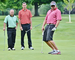 Jeff Lange | The Vindicator  Eric Ryan of Struthers (right), watches his missed putt go to the left of the hole as his teammates look on from behind.