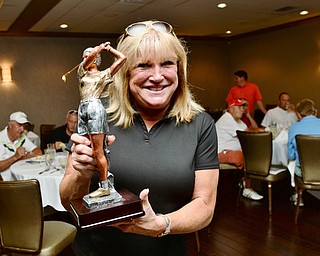 Jeff Lange | The Vindicator  Pam Porter shows off the trophy she won in Monday's women's longest drive competition.