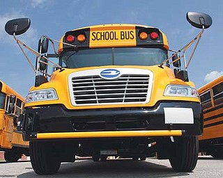 One of the new buses is displayed at an open house on the Austintown Local School District campus Thursday. Fourteen new propane-fueled buses will service the district’s longer routes when the 2014-15 academic year begins Monday.