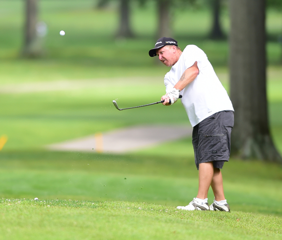 BOARDMAN, OHIO - AUGUST 22, 2014: Dave Campman of Austintown follows through on a approach shot on a hole on the north course Friday morning at Mill Creek Golf Course during the Vindy Greatest Golfer Tournament. (Photo by David Dermer/Youngstown Vindicator)