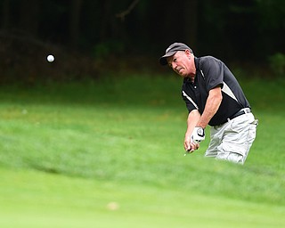 BOARDMAN, OHIO - AUGUST 22, 2014: Tom Shuster of Southington chips his ball from the short rough onto the green on the 18th hole on the south course Friday morning at Mill Creek Golf Course during the Vindy Greatest Golfer Tournament. (Photo by David Dermer/Youngstown Vindicator)