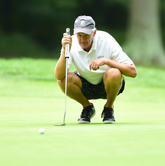 BOARDMAN, OHIO - AUGUST 22, 2014: Tom Korner of Salem lines up his putt on the 18th hole on the south course Friday morning at Mill Creek Golf Course during the Vindy Greatest Golfer Tournament. (Photo by David Dermer/Youngstown Vindicator)