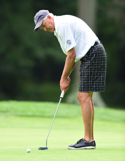 BOARDMAN, OHIO - AUGUST 22, 2014: Tom Korner of Salem follows through on his putt on the 18th hole on the south course Friday morning at Mill Creek Golf Course during the Vindy Greatest Golfer Tournament. (Photo by David Dermer/Youngstown Vindicator)