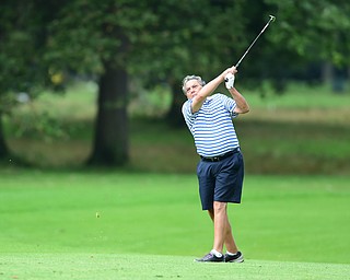 BOARDMAN, OHIO - AUGUST 22, 2014: Ron Mcgowen of Boardman follows through on his approach shot on the 9th hole on the south course Friday morning at Mill Creek Golf Course during the Vindy Greatest Golfer Tournament. (Photo by David Dermer/Youngstown Vindicator)