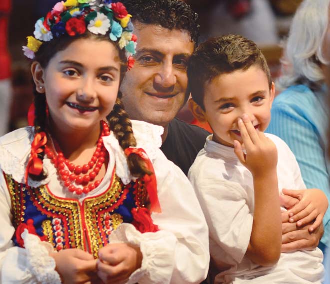 Isabella Khoury, 8, left, her father, Tony, and her brother Alex, 5, enjoy the Polish Heritage Celebration at the Saxon Club in Austintown on Sunday. “They’ve danced in the group for years,” Tony Khoury said. 