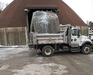 A Mahoning County Engineer’s office truck is loaded with salt before a February snowstorm. Local communities are working with the Ohio Department of Transportation and Morton Salt to lower prices for the coming winter.