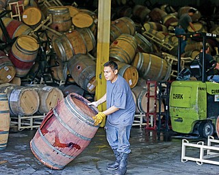 A worker removes an earthquake-damaged wine barrel from a barrel-storage facility Monday in Napa, Calif. A powerful earthquake that struck the heart of California’s wine country caught many people sound asleep, sending dressers, mirrors and pictures crashing down around them and toppling wine bottles in vineyards around the region. The magnitude-6.0 quake struck early Sunday near Napa. Businesses continued to clean up the mess Monday while encouraging visitors to keep flocking to the charming towns, tasting rooms, restaurants and spas that drive the Napa Valley economy.