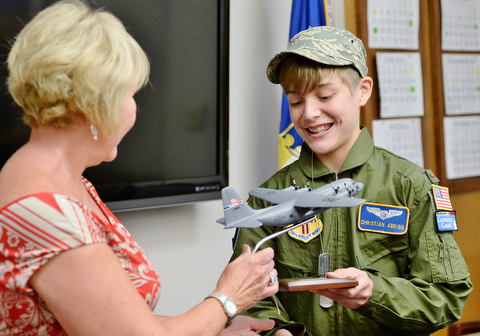 13-year-old Christian Abrigg (right) receives his model C-130 airplane from Marty Campa, human resource officer, Wednesday morning after being sworn in as an honorary Air Force Reserve member. Christian suffers from life-threatening allergies, asthma and an auto-immune disease.