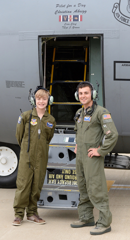  Christian Abrigg (left) stands with 1 Lt  Zachary Eberle (right) in front of his name on the side of one of the base's C-130's, Wednesday morning in Vienna.