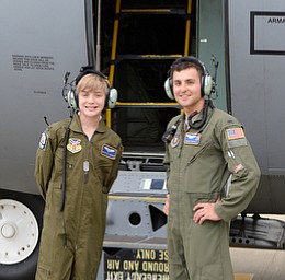  Christian Abrigg (left) stands with 1 Lt  Zachary Eberle (right) in front of his name on the side of one of the base's C-130's, Wednesday morning in Vienna.