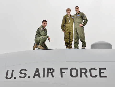 Major Rob Davies (left), Christian Abrigg (center) and 1st Lt. Zachary Eberle (right) pose for a photo on top of a U.S. Air Force C-130 airplane, Wednesday at the 910 Airlift Wing in Vienna.