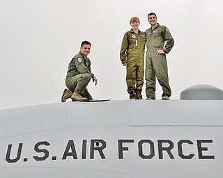 Major Rob Davies (left), Christian Abrigg (center) and 1st Lt. Zachary Eberle (right) pose for a photo on top of a U.S. Air Force C-130 airplane, Wednesday at the 910 Airlift Wing in Vienna.