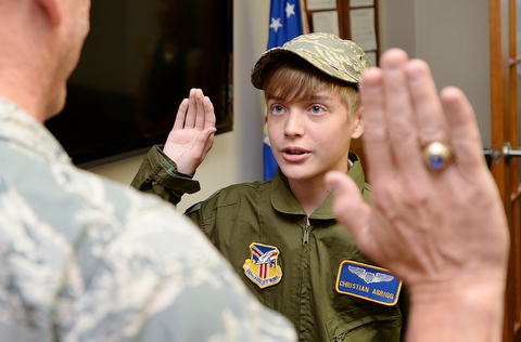 Christian Abrigg (13) of Canfield is sworn in by Col. David Post, Wednesday morning before the tour of the Air Force base in Vienna.