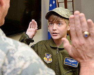 Christian Abrigg (13) of Canfield is sworn in by Col. David Post, Wednesday morning before the tour of the Air Force base in Vienna.