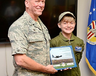 Col. David Post (left) and Christian Abrigg (13) of Canfield stand with his certificate for Pilot for a Day, Wednesday before the Air Force base tour.