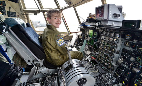 Christian Abrigg, 13, of Canfield smiles as he sits in the pilot's seat of a U.S. Air Force C-130 airplane, Wednesday during his experience of the Pilot for a Day program at the 910th Air Wing in Vienna.