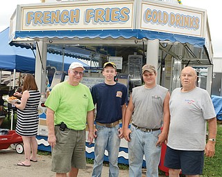 From left, Jim Rice, his grandson, A.J. Josephy, 14; Austin Gebhardt, 16, and his grandfather, Buzz Gebhardt, stand in front of the Springfield Township Ruritan concession stand. Buzz Gebhardt has worked at the stand for 30 years, and both grandfathers say they enjoy having their grandsons help out.