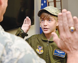 Christian Abrigg, 13, of Canfield is sworn in as an honorary Air Force Reserve second lieutenant by Col. David Post to start off Christian’s “Pilot for a Day” experience Wednesday at the Youngstown Air Reserve Station in Vienna.
