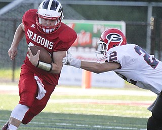 William D Lewis the Vindicator  Niles' (40) eludes  Girard's Nino Mayle(22) during 8-28-14 action in Niles.