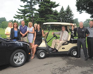 KATIE RICKMAN | THE VINDICATOR: Among those who are helping to organize the Tippecanoe Golf Classic at Tippecanoe Country Club in Canfield are, from left, Liz McGarry of Hospice of the Valley; Jill Mayfield; Dennis Sima, of Greenwood Chevrolet; Nancy Sullivan, director of sales at the country club; Leslie Coalmer; Diane Ross; Dr. Marty Raupple; Bob Ferraro, president of the club; and Michael Spiech, who is golf pro at the club.