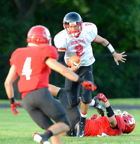 Jeff Lange | The Vindicator  Stephan Elash jumps past the tackle of Struthers linebacker Cameron Suchora for a gain in the first quarter Thursday evening at Struthers High School.