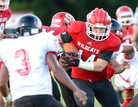 Jeff Lange | The Vindicator  Struthers fullback Auz Seifert (right) breaks through the line for a small gain for the Wildcats in the first quarter.