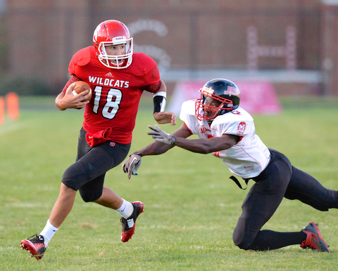 Jeff Lange | The Vindicator  Campbell's Lazerus Lebron dives out to tackle Struthers starting QB A.J. Musolino as he rushes for a touchdown in the first quarter, Thursday night in Struthers.