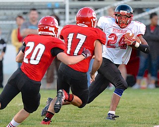 Jeff Lange | The Vindicator  Campbell's Mike Willim rushes for yardage past the defense of Struthers' Robbie Best (far left) and Andy Deem (center) in first half action, Thursday night in Struthers.