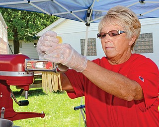 Angela Faris of Jamestown makes fresh noodles at the Granny Franer’s Homemade Noodles stand at the fair.