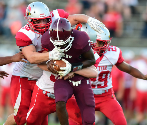 BOARDMAN, OHIO - AUGUST 29, 2014: Quarterback Marcus Smith #7 of Boardman is sacked by defensive linemen Trevor Morrison #50, linebacker J.D. Matsko #32, and defensive back Kenny Cook #29 of Mentor during the 2nd quarter of Friday nights OHSAA football game at Boardman Spartans Stadium. (Photo by David Dermer/Youngstown Vindicator) Linebacker Bradie Crandell #46 pictured.