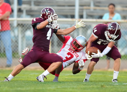 BOARDMAN, OHIO - AUGUST 29, 2014: Defensive back Matt Filipovich #14 of Boardman intercepts a pass intended for receiver Jarrell Jackson #3 of Mentor during the 2nd quarter of Friday nights OHSAA football game at Boardman Spartans Stadium. (Photo by David Dermer/Youngstown Vindicator) Linebacker Bradie Crandell #46 pictured. Defensive back Jon Cina #4 in coverage.