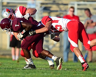 BOARDMAN, OHIO - AUGUST 29, 2014: Quarterback Marcus Smith #7 of Boardman is sacked by defensive linemen Trevor Marrison #50 and Pete Kunka #45 of Mentor during the 1st quarter of Friday nights OHSAA football game at Boardman Spartans Stadium. (Photo by David Dermer/Youngstown Vindicator)