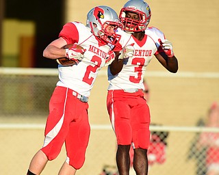 BOARDMAN, OHIO - AUGUST 29, 2014: Receiver Jason Blizzard #2 of Mentor celebrates with teammate Jarrell Jackson #3 after catching a touchdown pass on a halfback pass during the 1st quarter of Friday nights OHSAA football game at Boardman Spartans Stadium. (Photo by David Dermer/Youngstown Vindicator)