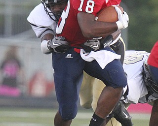 William D Lewis The Vindicator Fitch QB Antwan Harris(18 eludes an unidentified Warren tackler during First half action Friday at fitch.