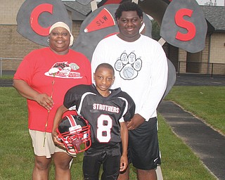 Leslie Carson with her sons Noah, 9, center, and Christian, 15. Leslie suffers from cancer, and some parents from the Struthers Little Wildcats and other community members will host a spaghetti dinner Sept. 13 to help pay for her treatments.