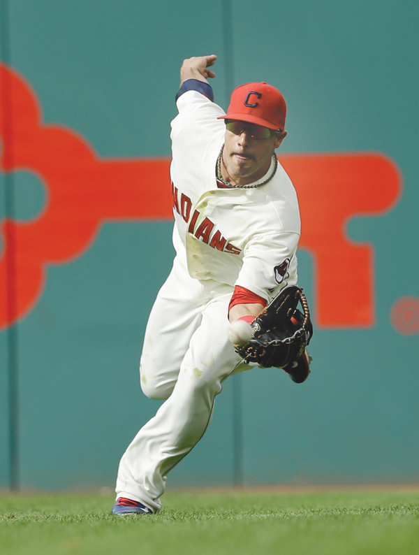 Indians right fielder Mike Aviles can’t hold onto a ball hit by Detroit’s Miguel Cabrera in the third inning Monday at Progressive Field in Cleveland. Cabrera was safe at first with a single. The Tigers beat the Indians, 12-1.