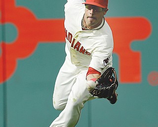 Indians right fielder Mike Aviles can’t hold onto a ball hit by Detroit’s Miguel Cabrera in the third inning Monday at Progressive Field in Cleveland. Cabrera was safe at first with a single. The Tigers beat the Indians, 12-1.