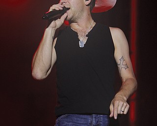 Country music artist Justin Moore sings to a crowd of about 5,000 during his concert at the Canfield Fair grandstand Monday night.