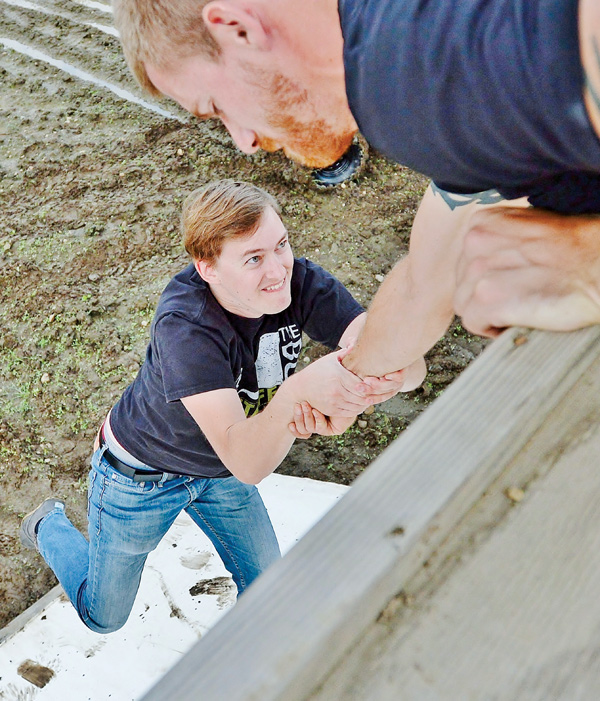 Chad Macek of Hubbard helps out Rick Courtney as he tries to climb “Da Wall,” a half-pipe on the Burner. The Burner, a 7-mile mud run with 30 natural and manmade obstacles, bills itself as “Ohio’s toughest seven miles.” Registration continues for the benefit for Akron Children’s Hospital.