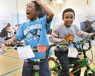 Brothers Joshua, 7, left, and Anthony Dees, 8, check out the bicycles they were given at the Boys and Girls Club of Youngstown Wednesday. The bikes were provided by a Girard couple who wished to remain anonymous.
