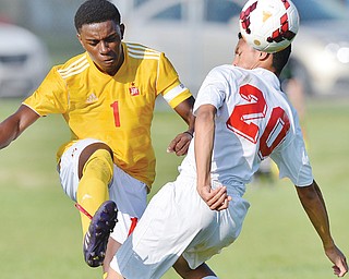 Cardinal Mooney senior captain Myles Harris kicks the ball over the shoulder of Warren JFK’s Marco Lucero during the first half of their game Wednesday in Warren. The Cardinals downed the Eagles, 6-0, behind sophomore Chris Perry who scored three goals.