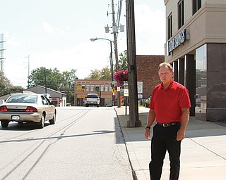 Struthers Mayor Terry Stocker stands on a State Street sidewalk, near where five new streetlights will be installed within the next few weeks. He’s hopeful that lighting improvements, among others, will help to revitalize the city’s downtown.