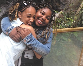 Charmaine Carlisle, daughter of Neika Carlisle of Youngstown, and her friend Tyra share a wholehearted embrace of friendship.