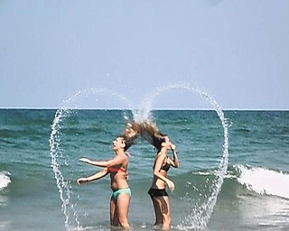 Samantha Wadman and her friend Erin Lorimer were on a beach, where they were able to create friendship hearts with their hair. They've been friends since elementary school.